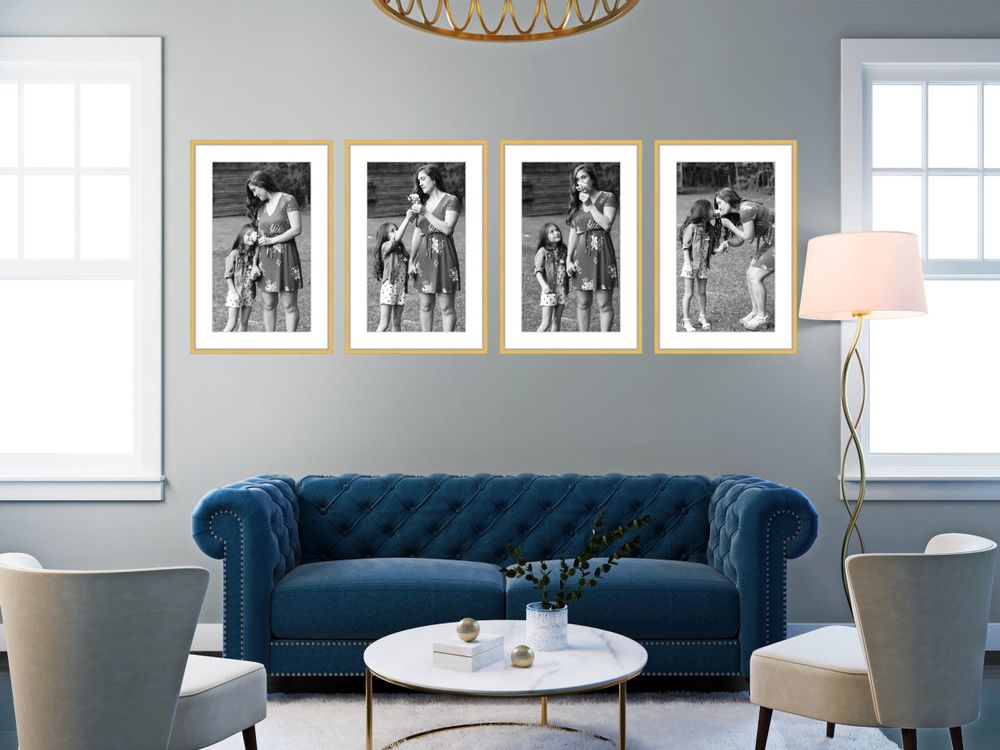 Living room with navy blue Chesterfield sofa and framed black and white gallery wall.