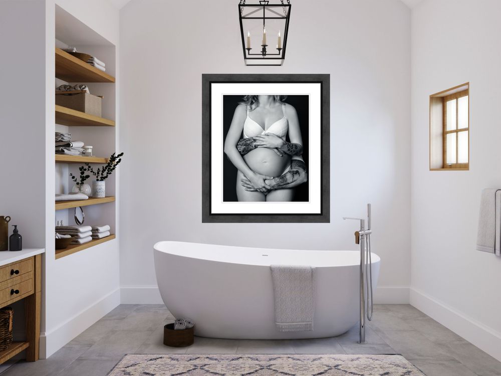 Minimalist bathroom with modern freestanding tub and large framed black and white photograph.
