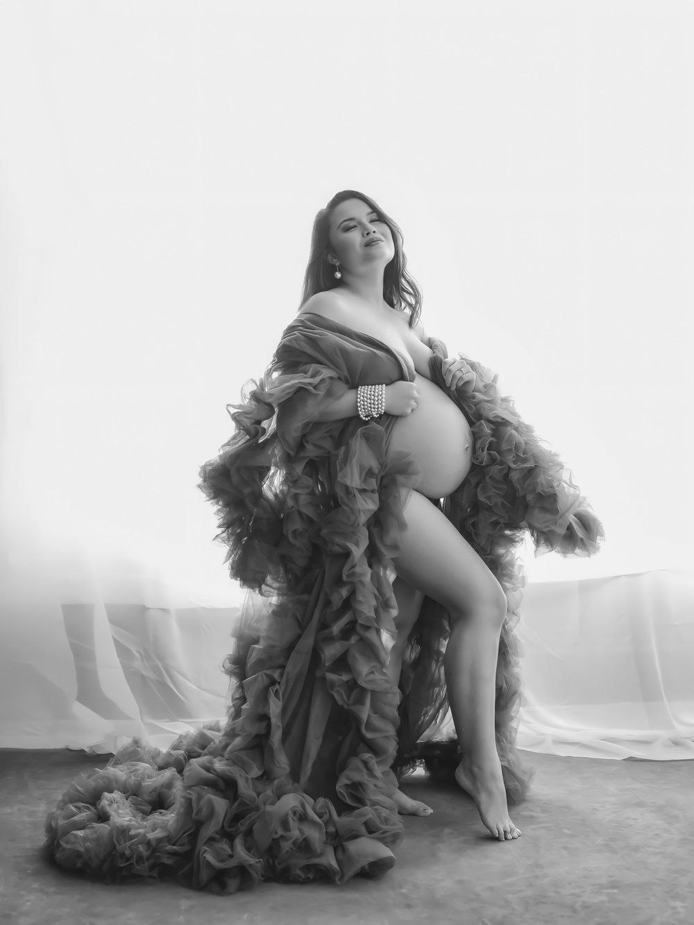 Raleigh maternity photographer.  Stunning photo of a maternity client in an elegant robe.  studio in raleigh