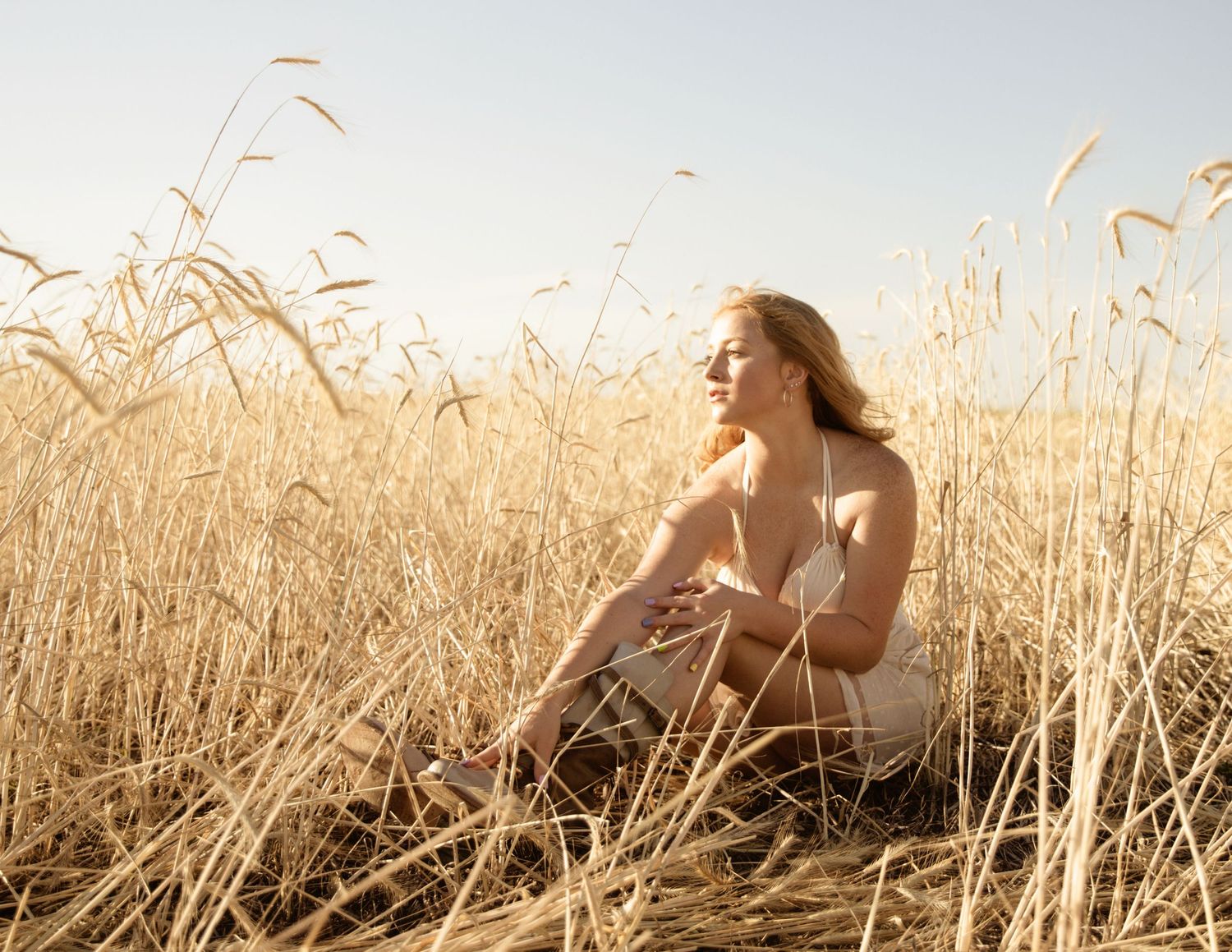senior shoot in wheat field at golden hour