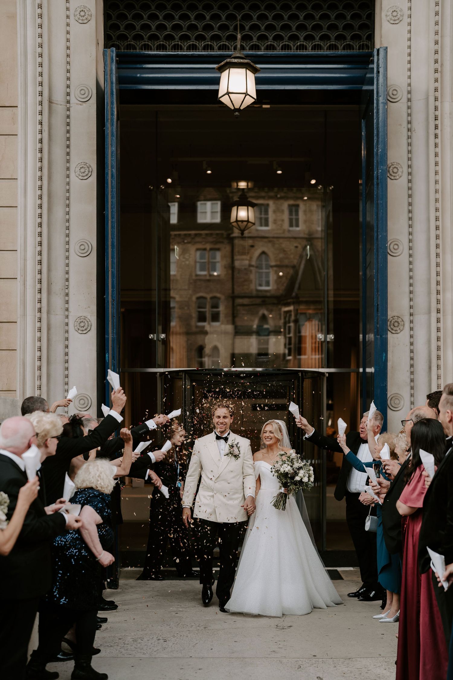 confetti being thrown over bride and groom as they leave the Ashmolean Museum