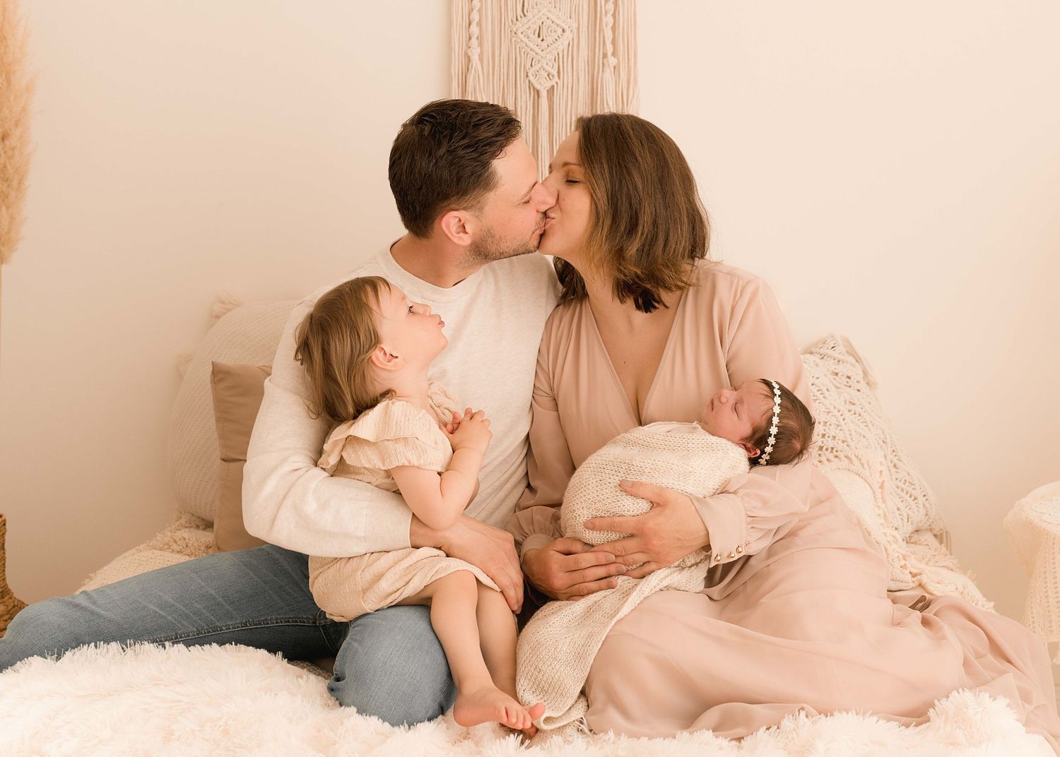 Intimate family portrait session with soft neutral tones and natural lighting.
