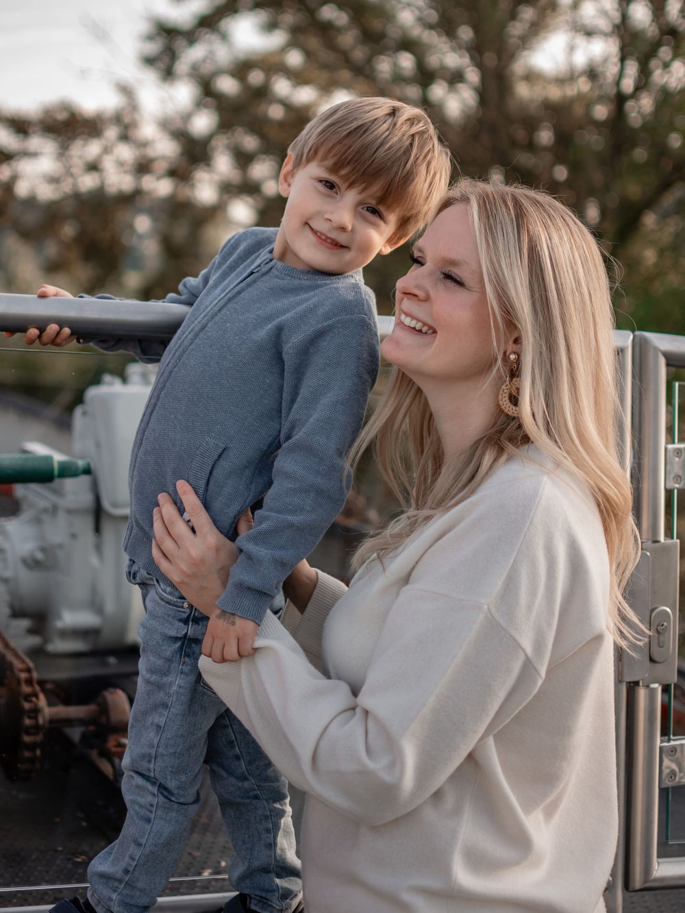 A heartwarming interaction between parent and child sharing smiles and embraces outdoors.