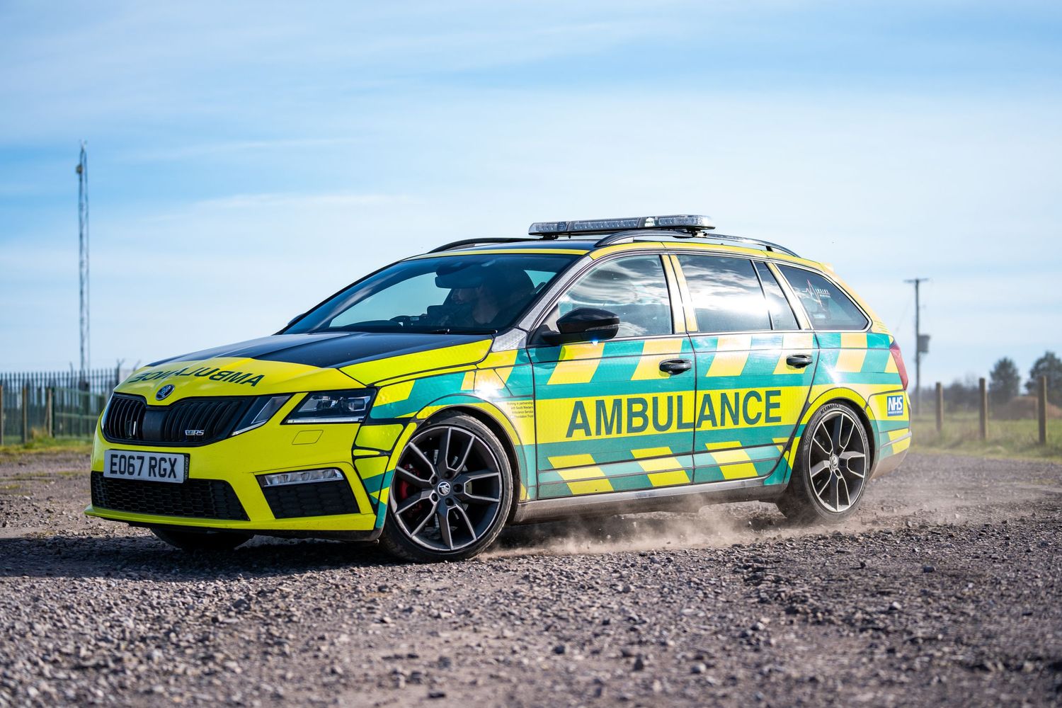 High-performance Skoda emergency response vehicle in bright yellow ambulance livery.