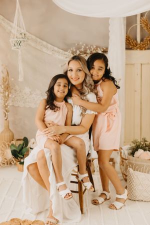 Family sharing joyful moments together on white furniture with festive decorations.
