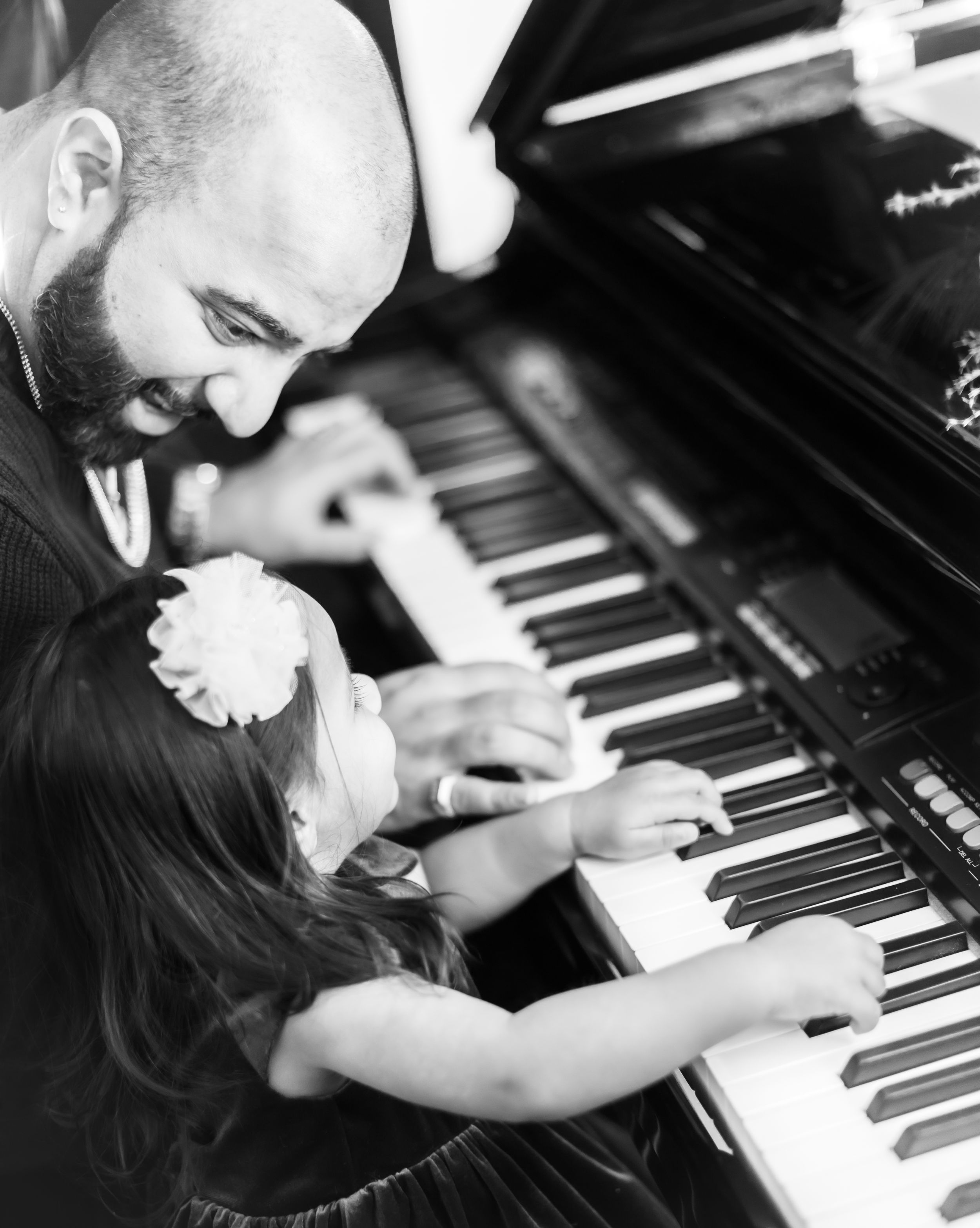 Black and white photos of hands playing piano keys in an artistic composition.