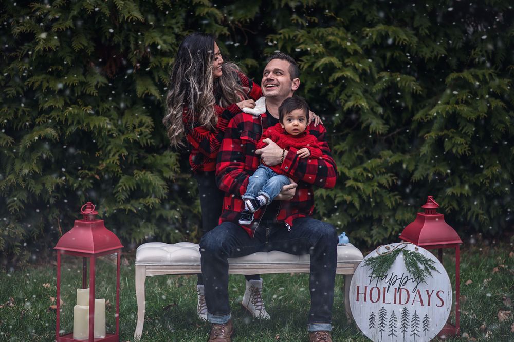 A festive holiday family portrait with red lanterns and decorative signs.
