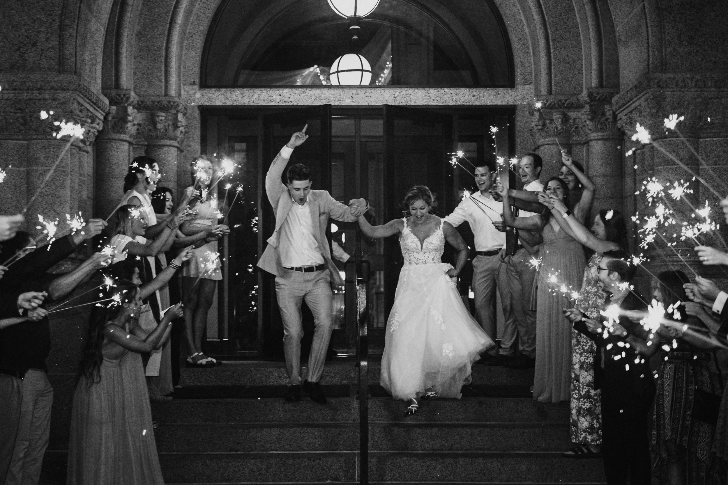 A bride and groom leave their reception during a sparkler exit