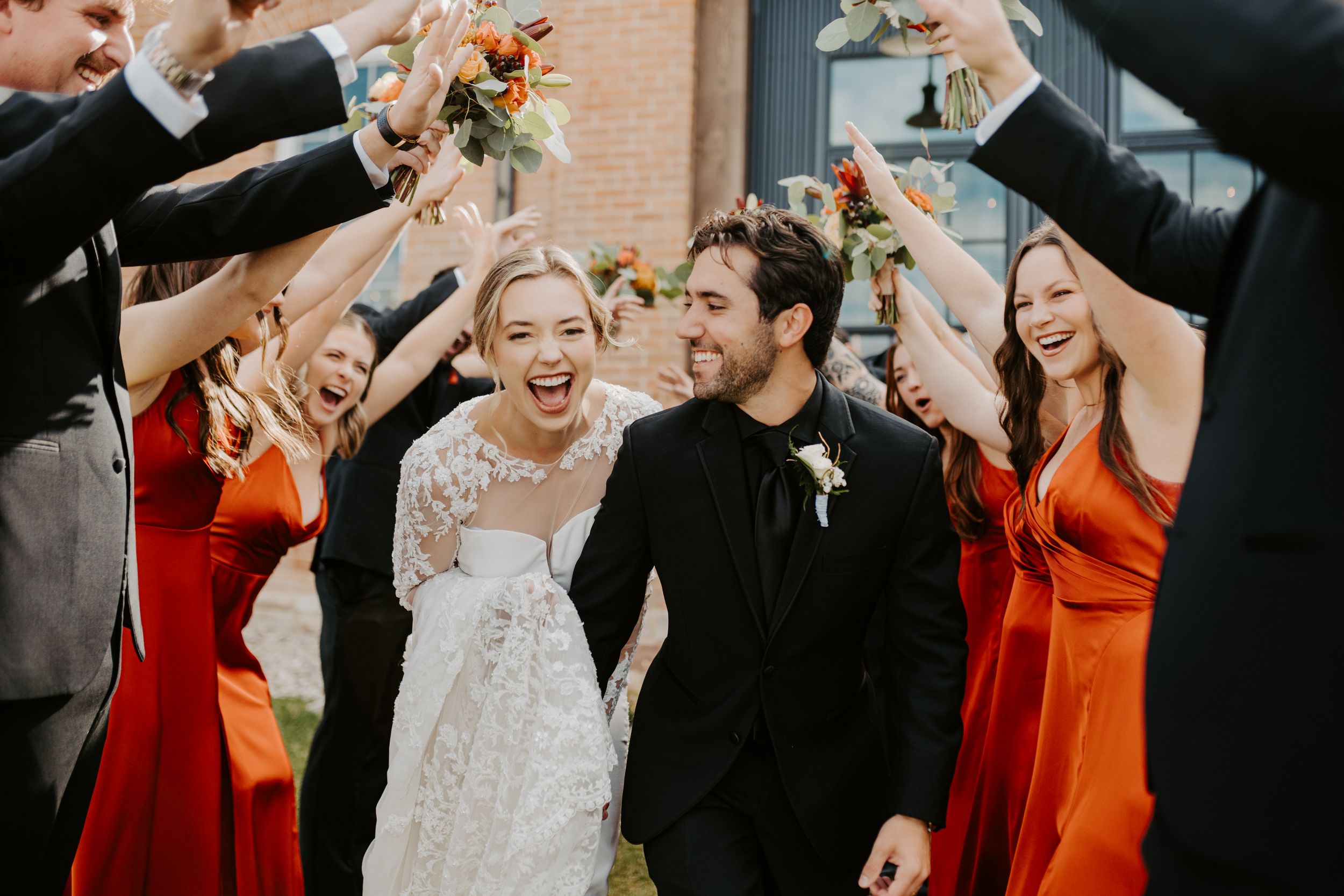 A bride and groom walk through their bridal party in Northern Colorado