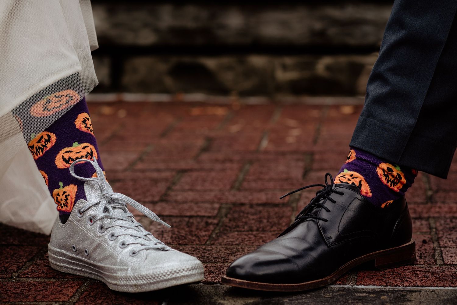 LGBTQ+ same sex lesbian couple show off their matching halloween socks
