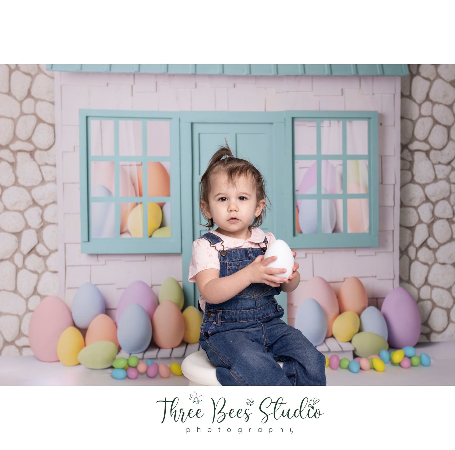 Easter backdrop with pastel eggs and blue windows creating a charming spring scene.