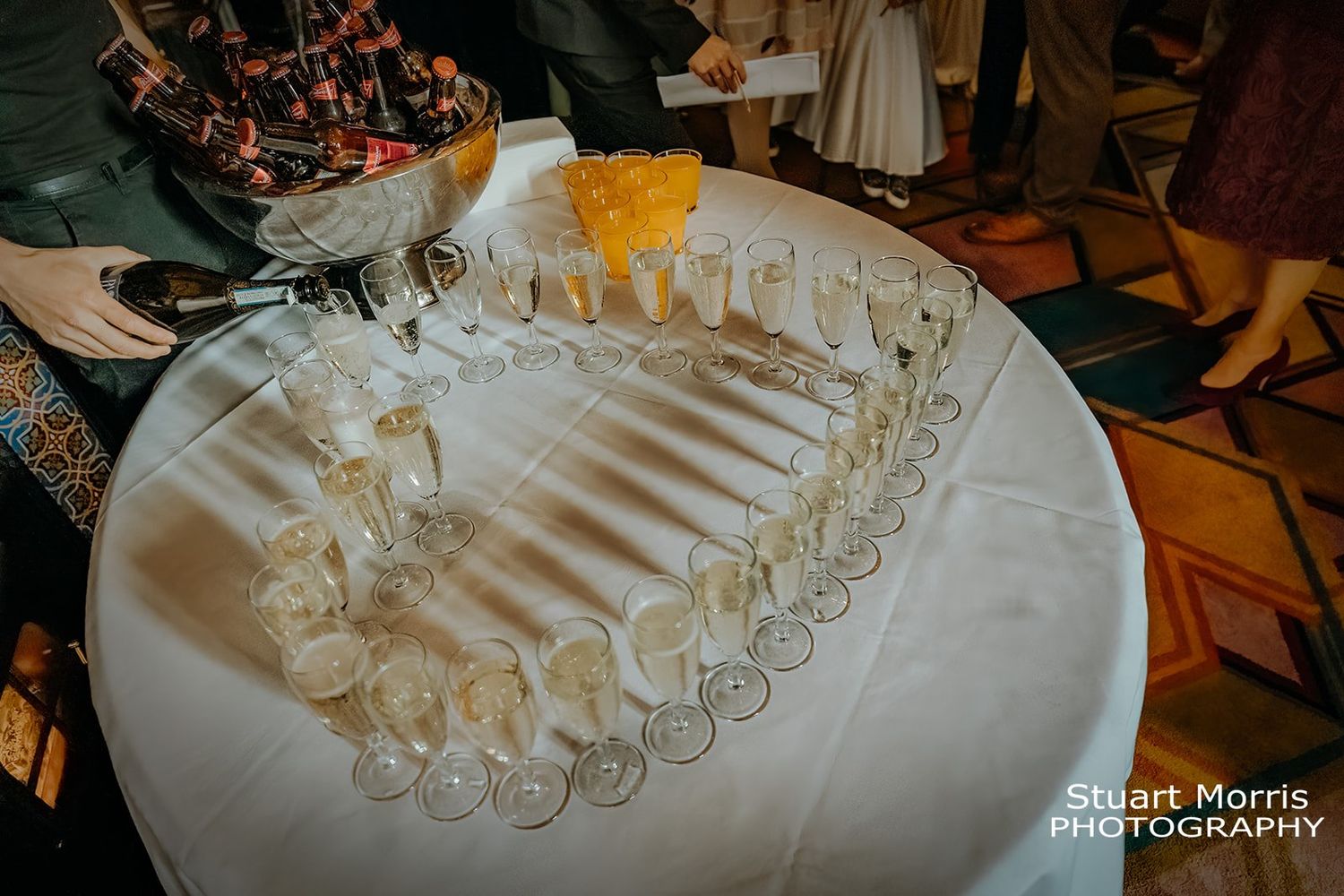 Champagne glasses in a hearth shape ready for wedding guests at Ruthin castle. Stuart Morris Photography.