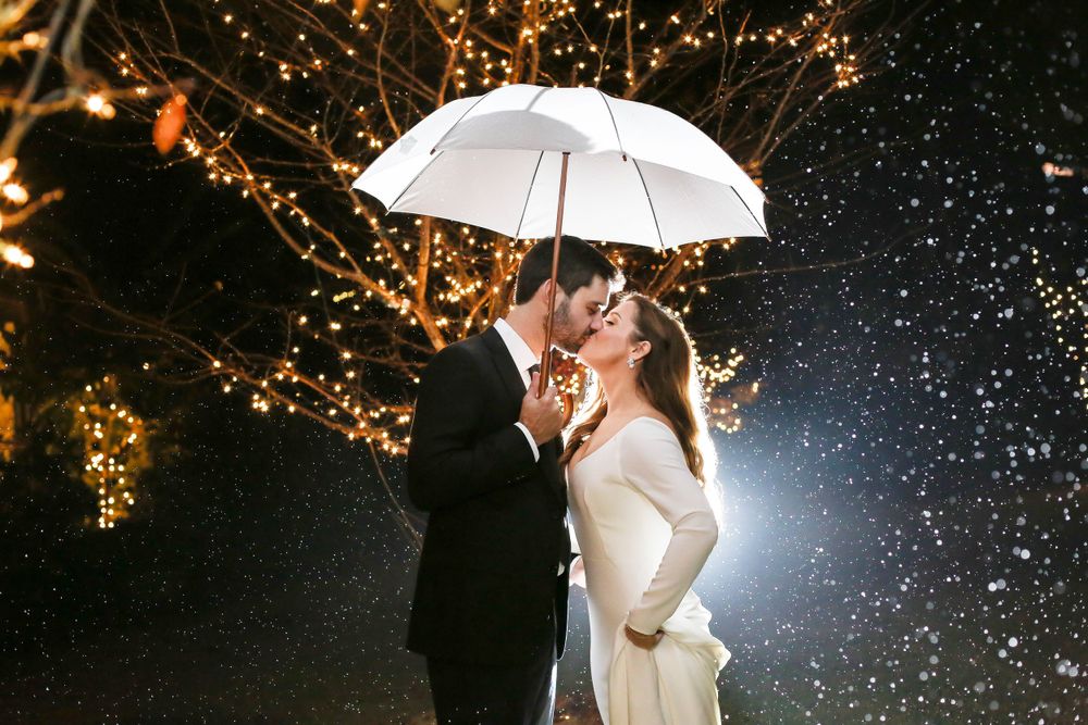 Wedding Couple kissing in the rain at the Crest Pavilion in Asheville