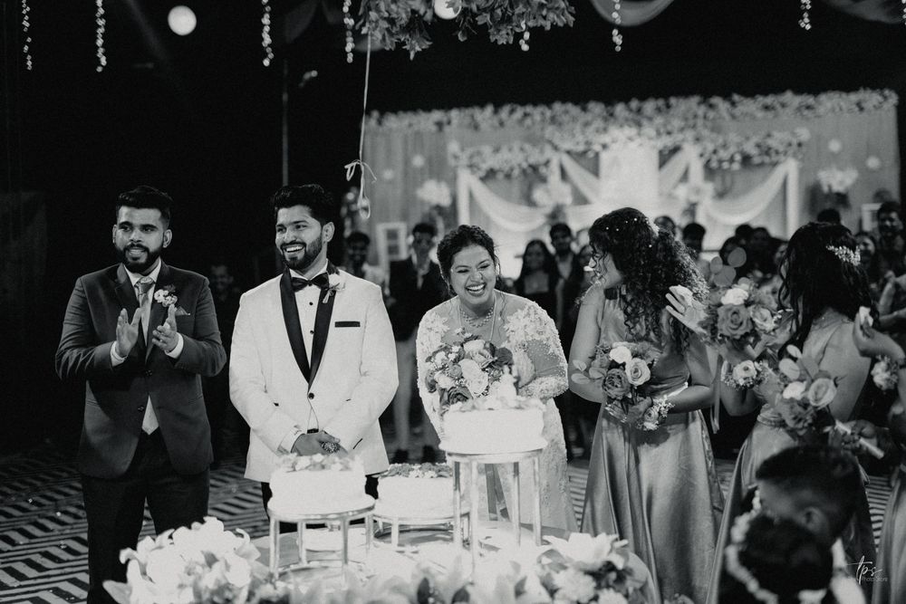 Black and white wedding reception photo shows guests enjoying the celebration.