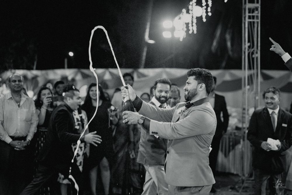 Black and white photo of couples dancing together at an elegant wedding reception.