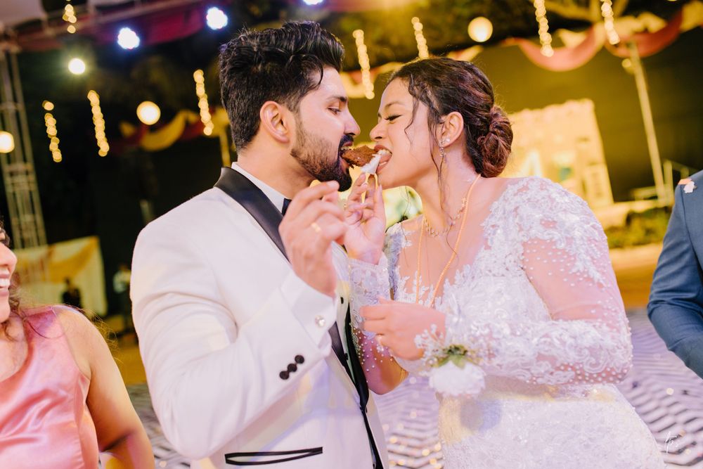 Romantic wedding reception scene with floral decor and warm lighting as couples share intimate moments.