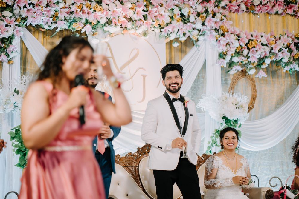 Elegant wedding venue decorated with pink and white floral arrangements and romantic lighting.