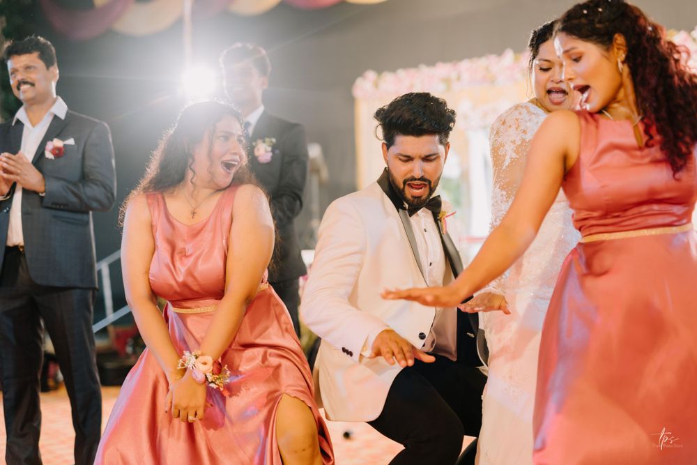 Wedding guests dance and celebrate on a festively decorated dance floor at an evening reception.