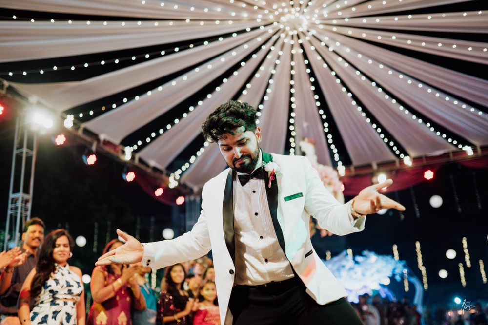 Dramatic tent ceiling with radiating string lights creating a starlit effect over a dance floor.
