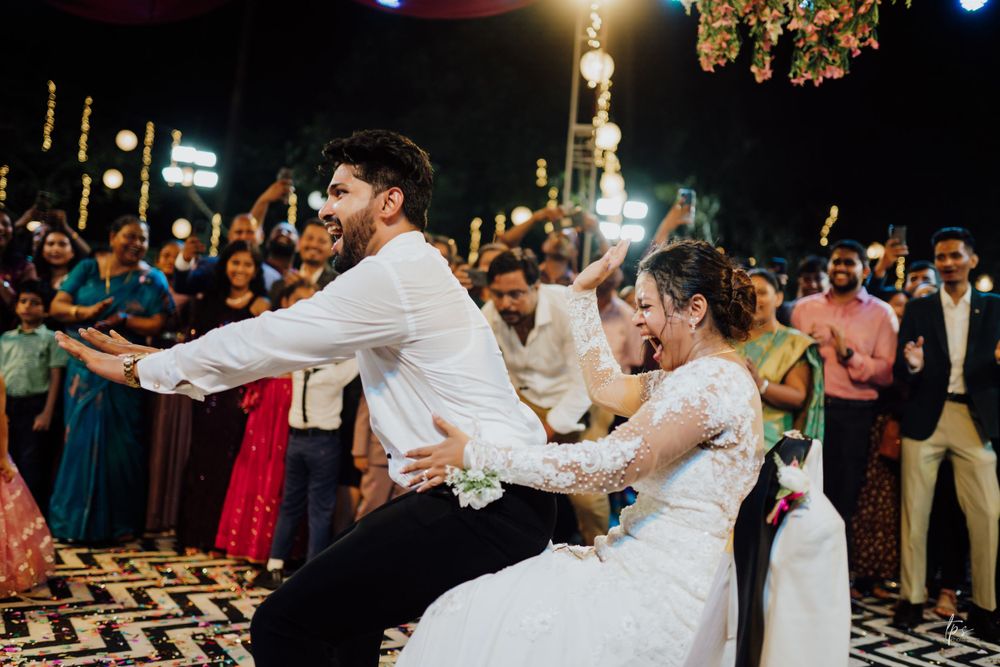 Evening wedding reception showing dance floor moments under decorative lighting.