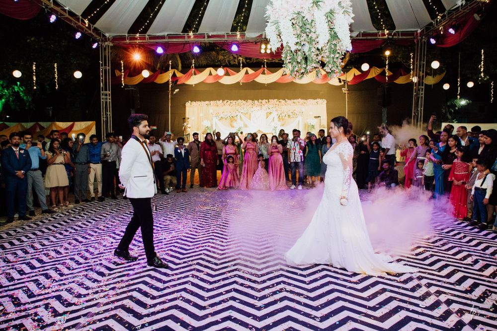 A wedding celebration on a dramatic chevron dance floor with purple lighting and fog effects.