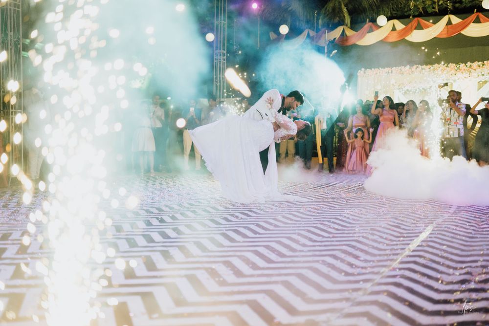 Wedding couple dancing amid fog effects on a striking chevron patterned dance floor.