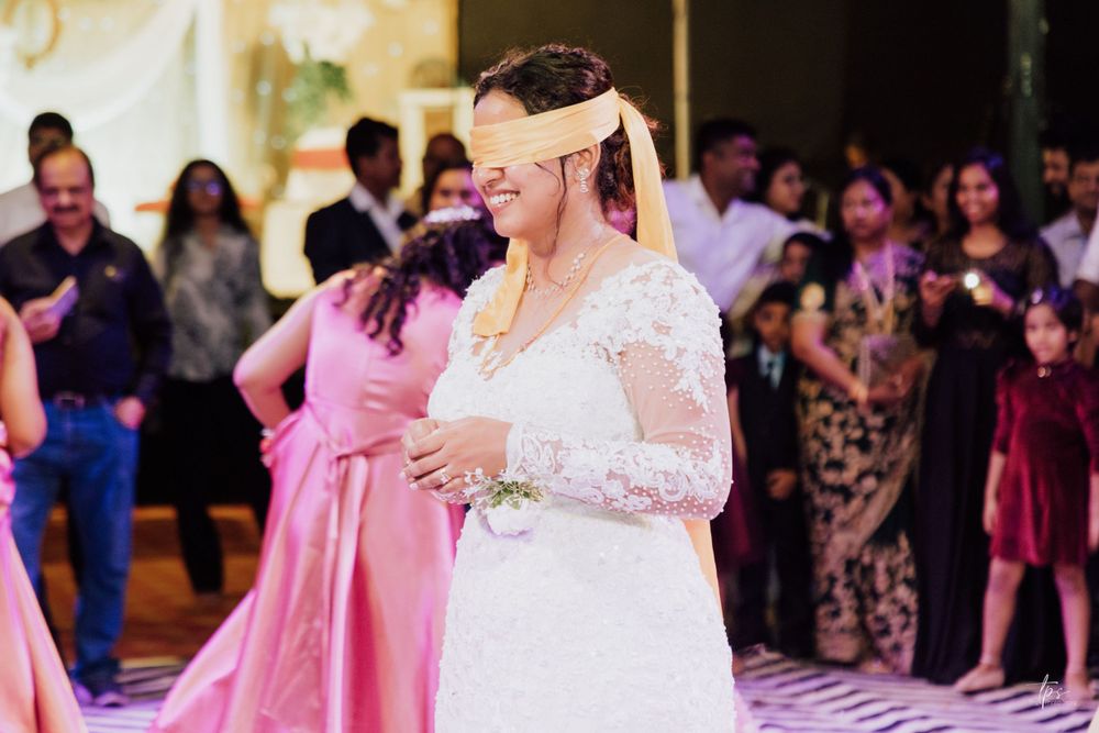 Wedding celebration on a black and white chevron dance floor with guests in formal attire.