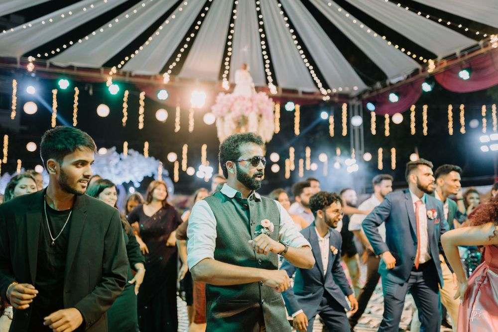 Wedding venue features dramatic ceiling draping with string lights creating an elegant atmosphere.