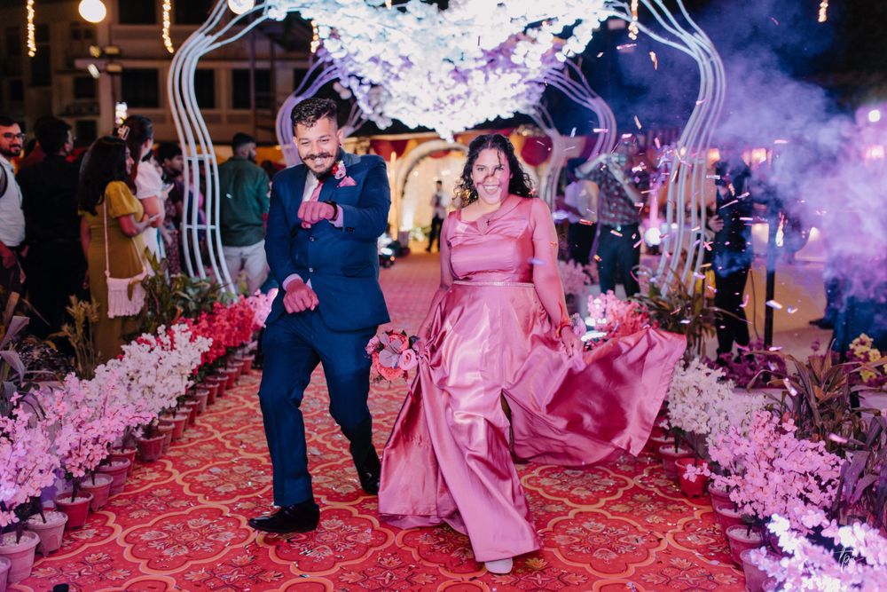 Wedding couple dances surrounded by pink decor and theatrical smoke effects.