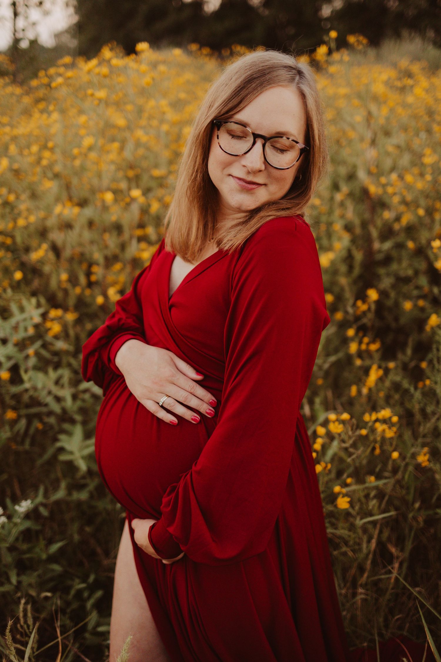 mom in flower field during maternity photography session