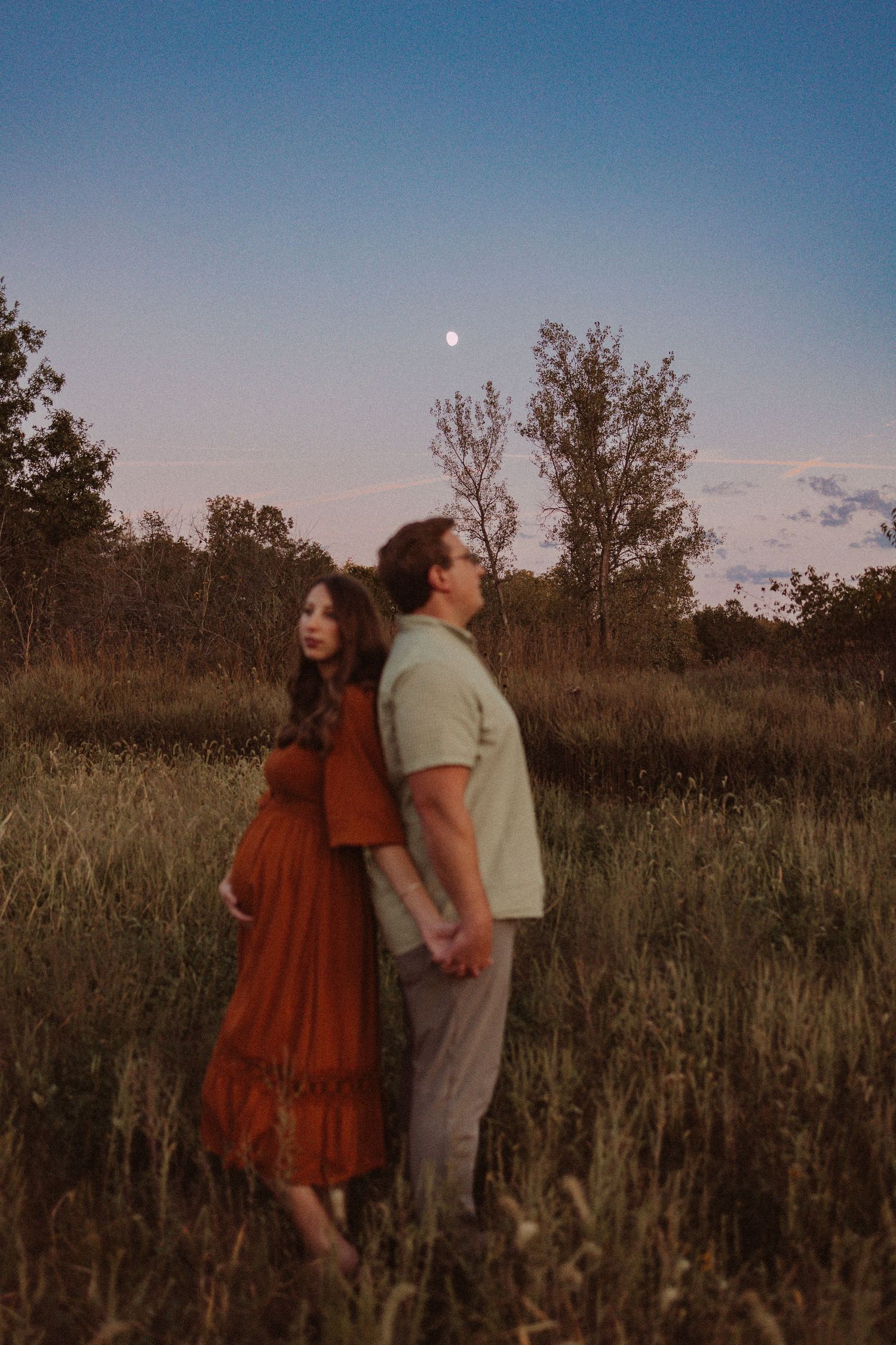 moon focused maternity session in a field
