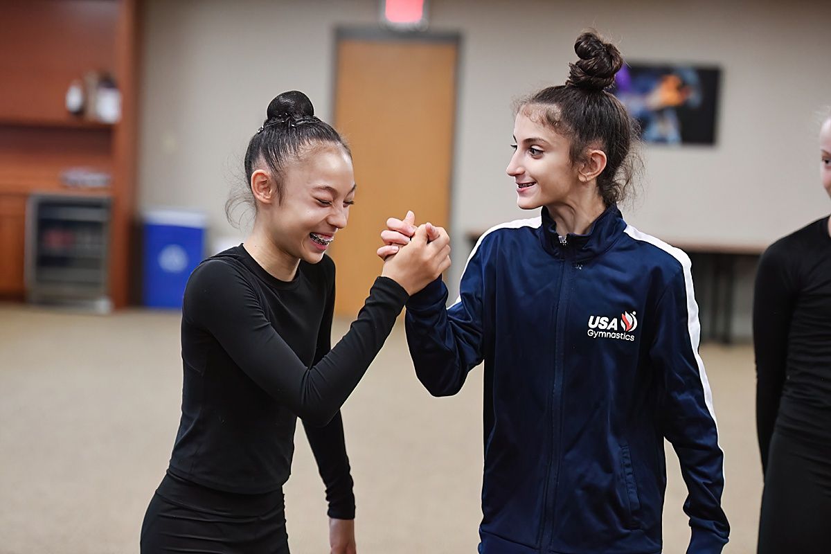 Rhythmic Gymnasts smiling and celebrating