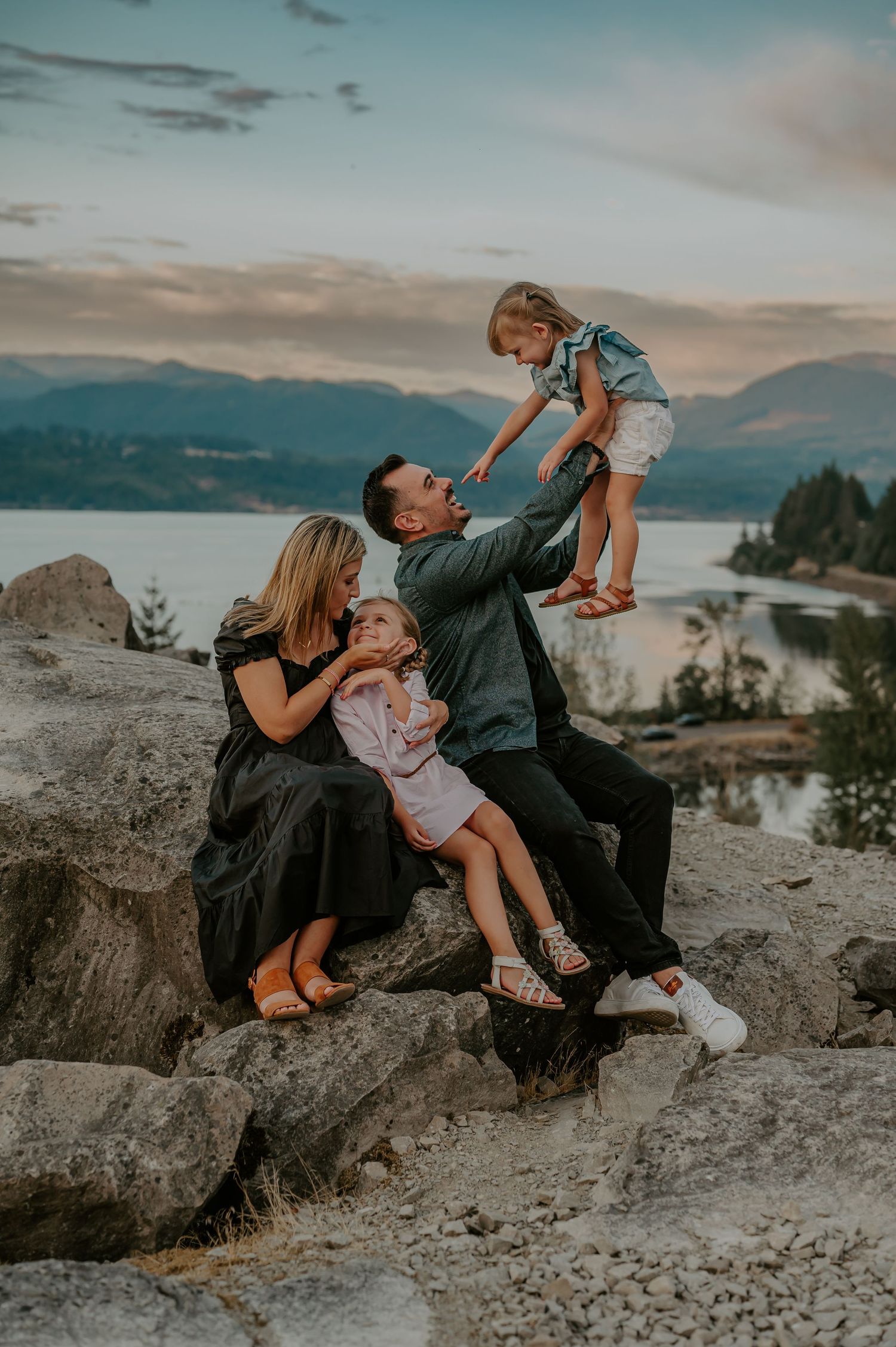 Family sits on a rock