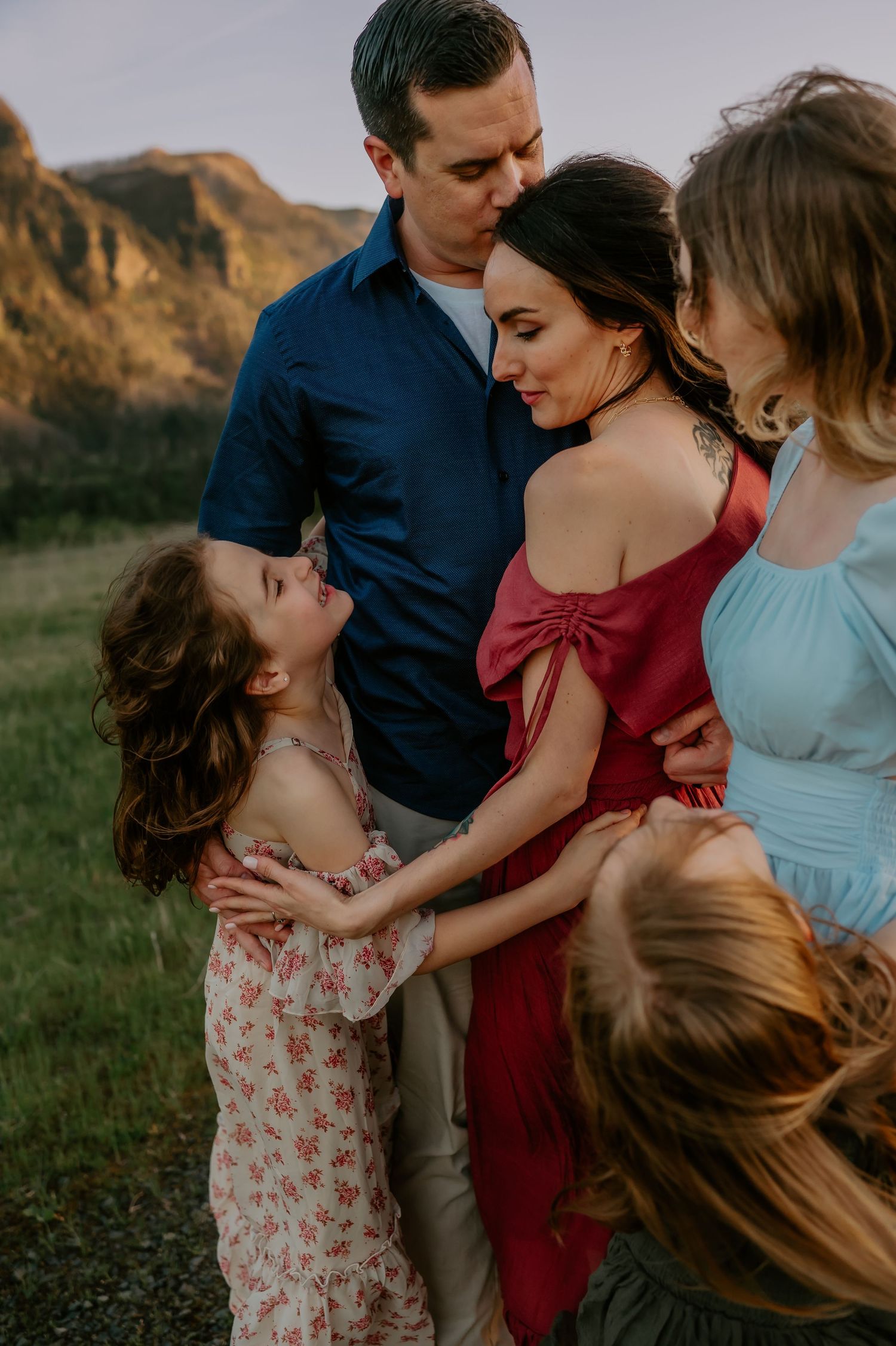 Family embracing in a field
