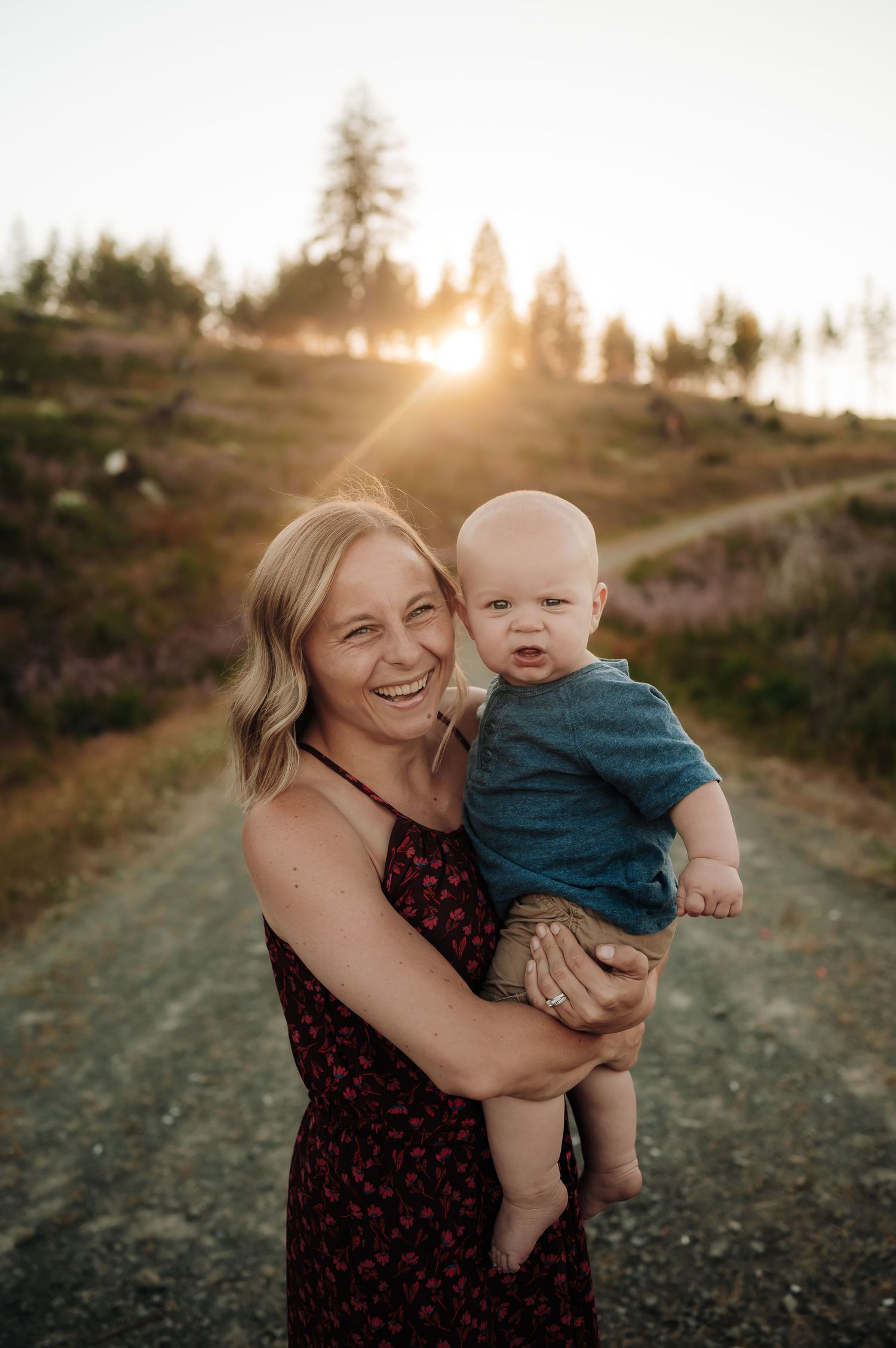Mother holds her young son on a trail