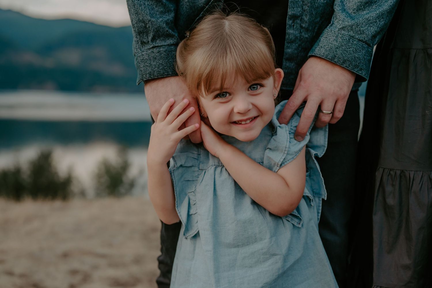 Daughter stands in front of her parents