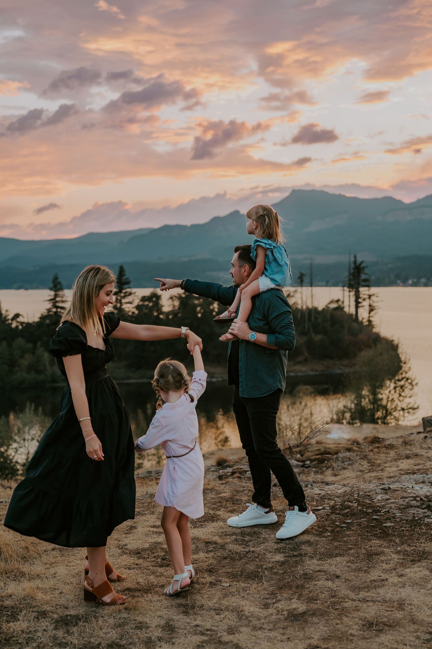 Family dancing beside a river