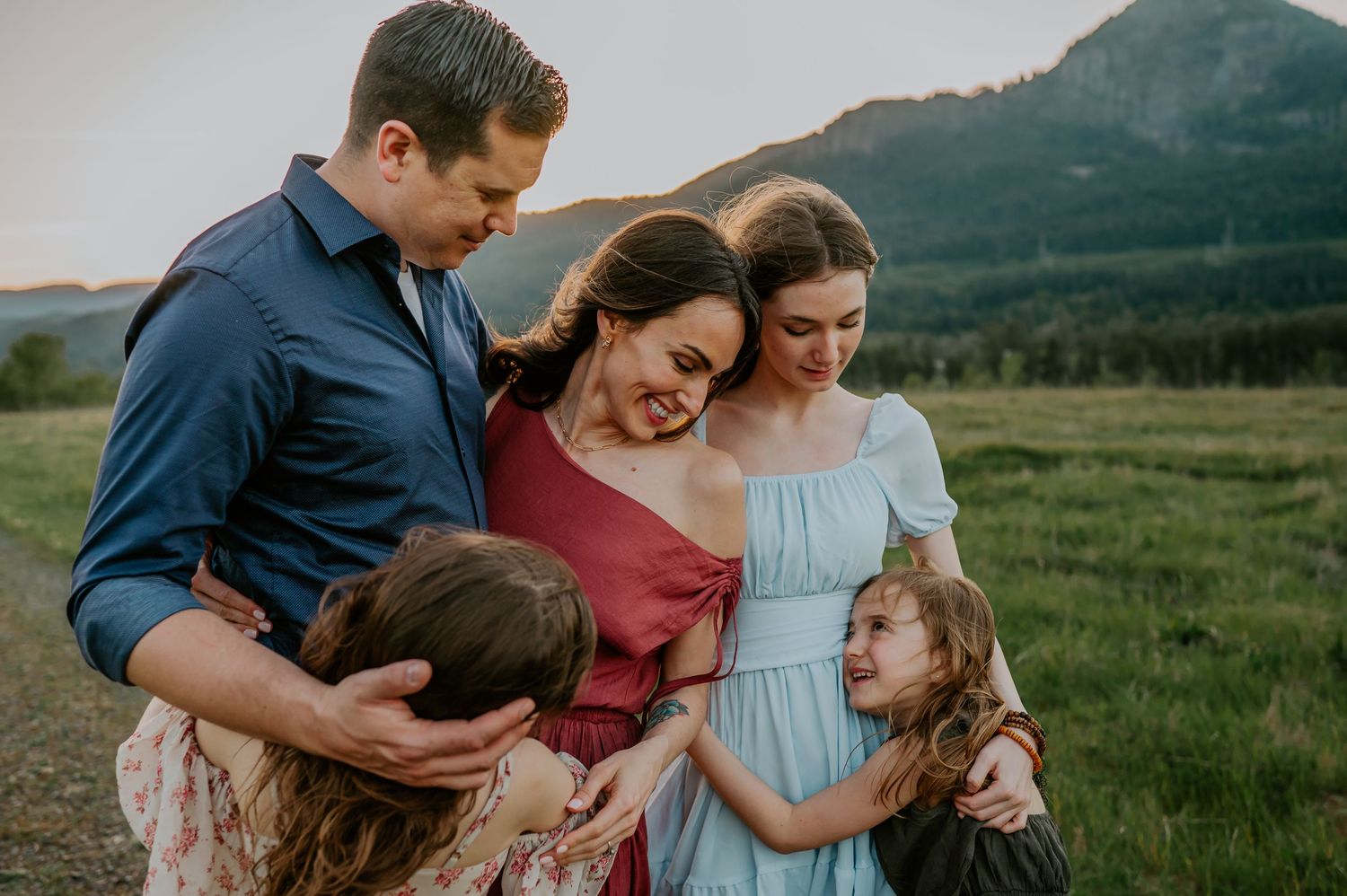 Family embracing in a field