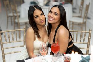 Two guests enjoying cocktails together at an elegant table setting.