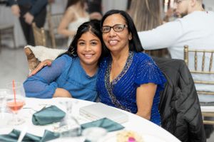 Two guests sharing a joyful moment at an indoor celebration.