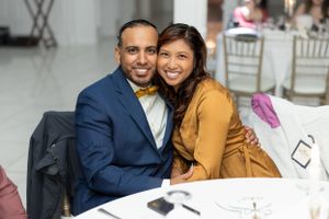 Couple posing together at an indoor event with elegant decor.