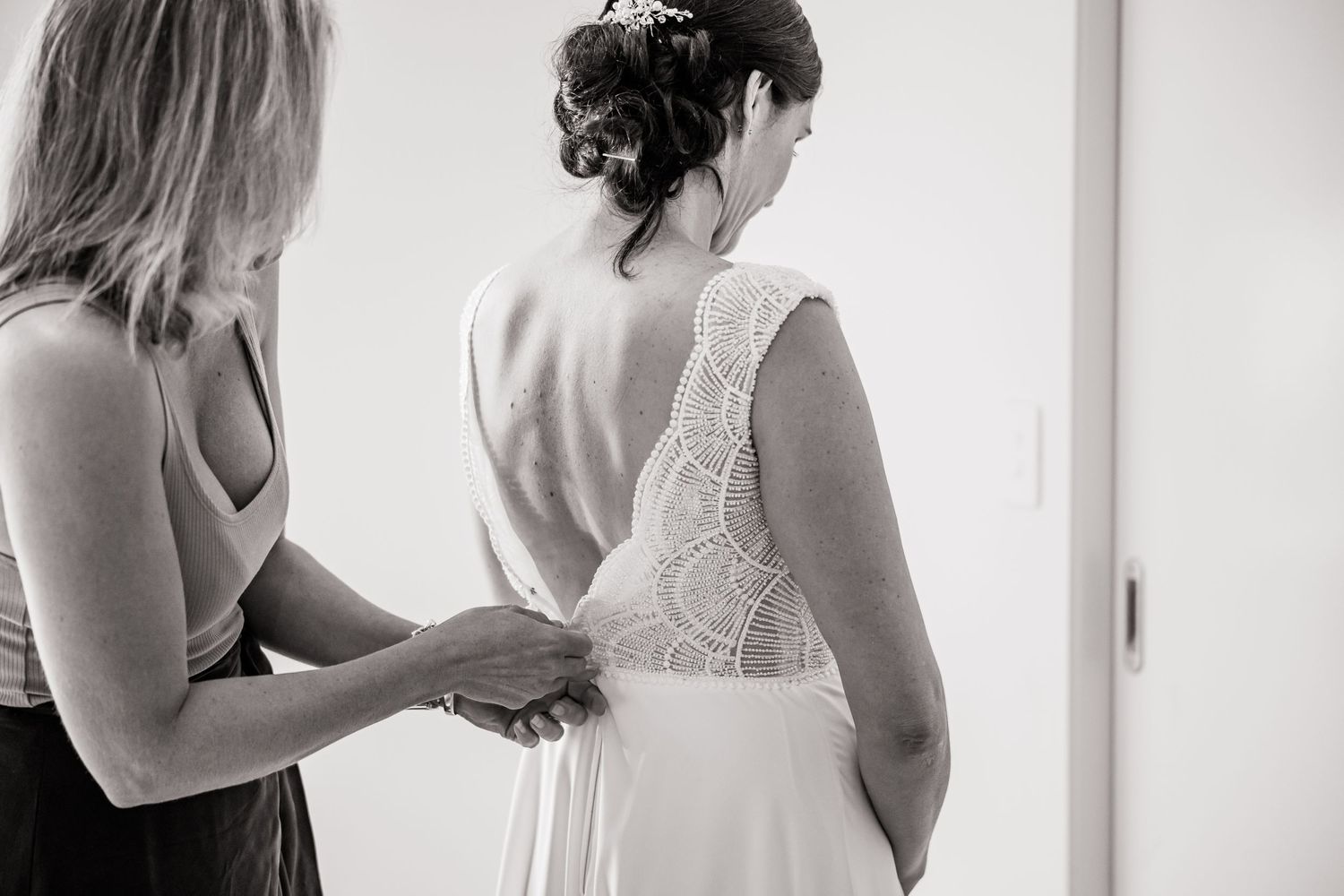 Intimate wedding preparation moments captured in black and white.
