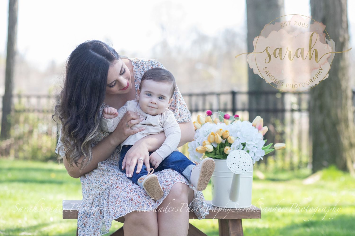 Mom and baby sitting on bench at park