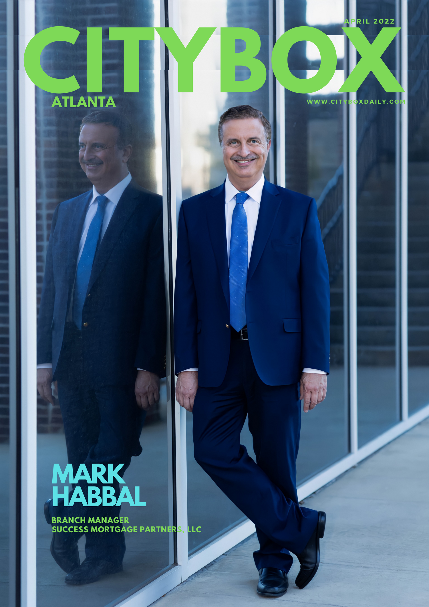 business man full body portrait smiles on camera reflection blue suite