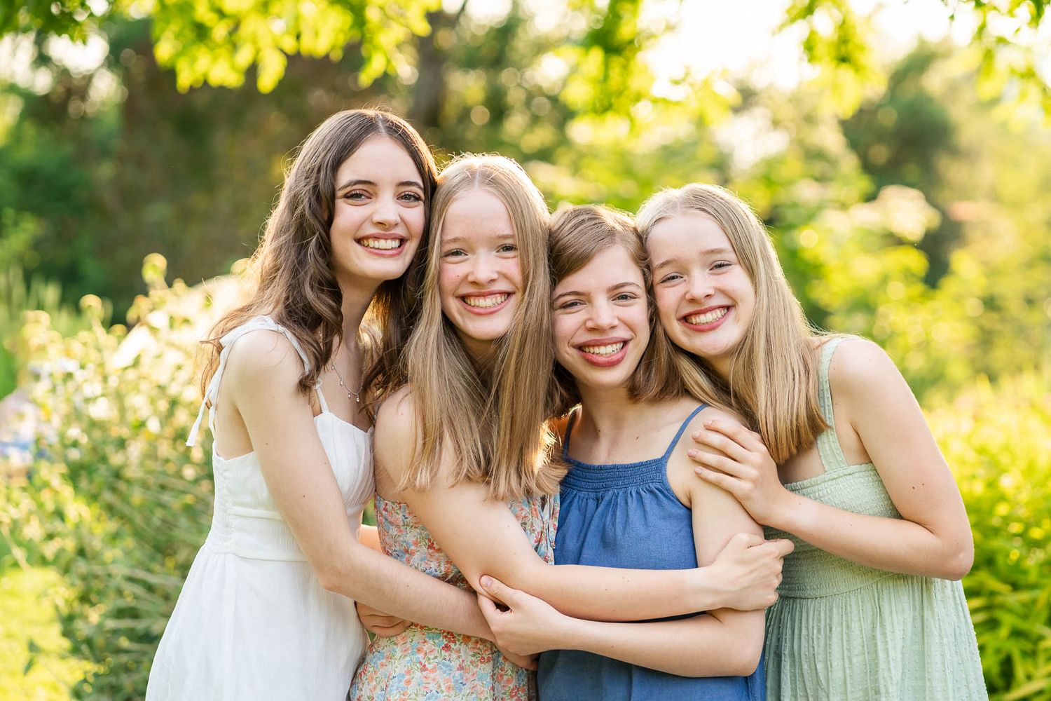 Portrait of sisters smiling at Bellevue Botanical Garden in the spring.