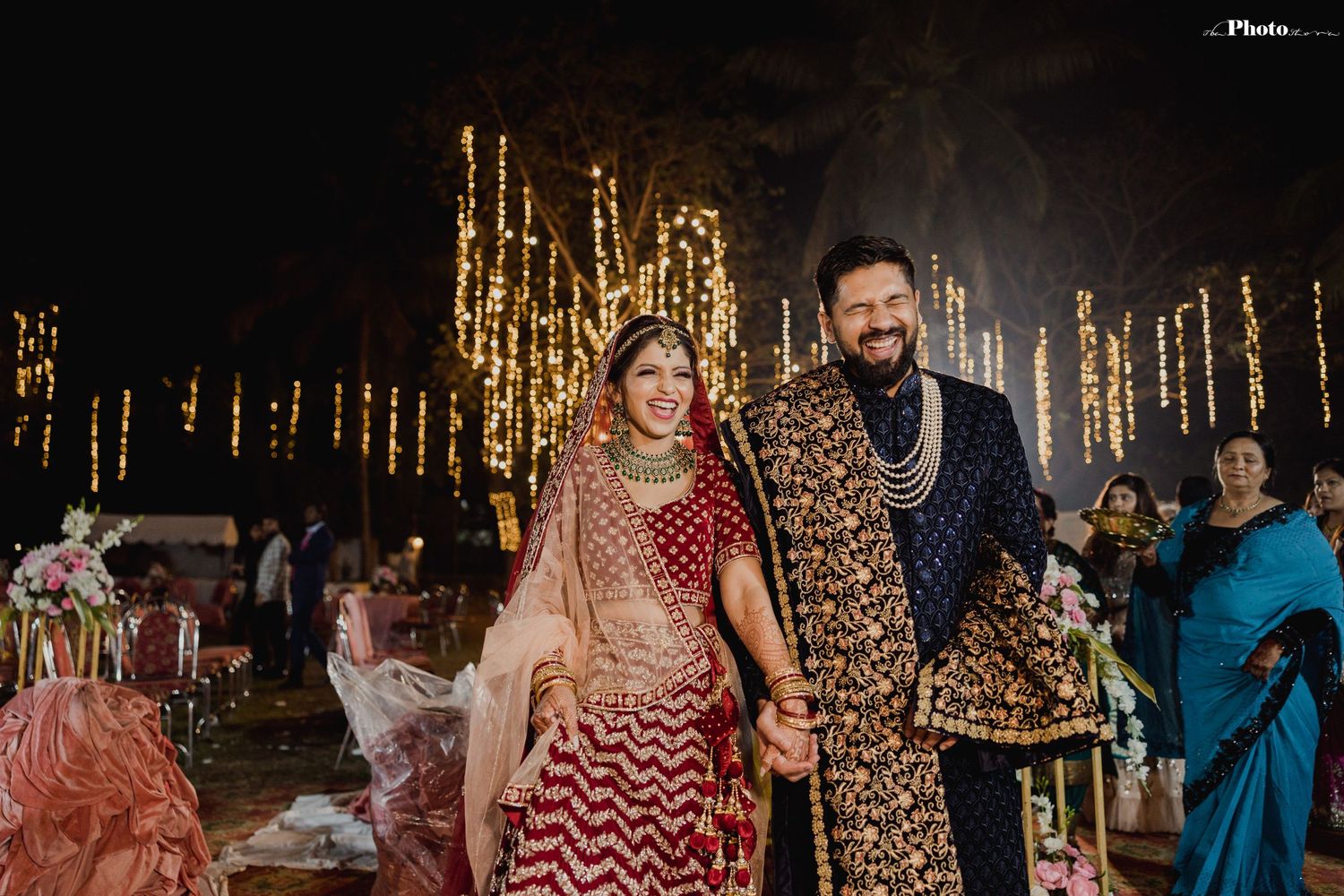 Romantic wedding photoshoot with string lights creating a magical bokeh effect in the background.