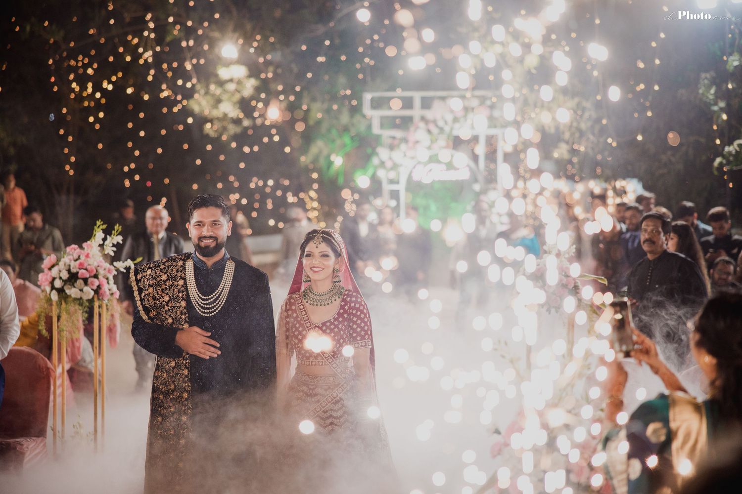 A magical wedding entrance with sparklers creating a dreamy atmosphere.