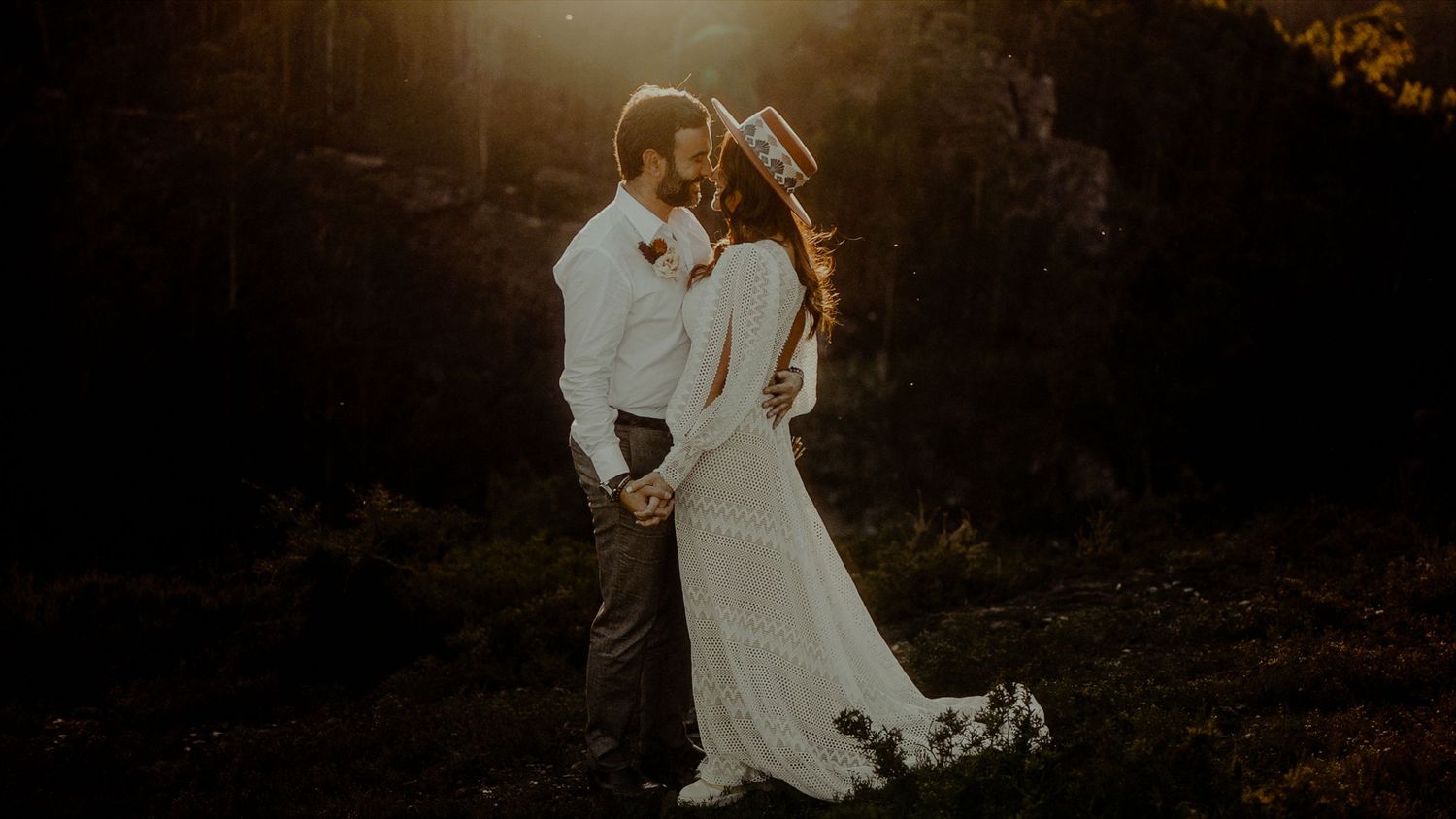 A romantic golden hour portrait of newlyweds in nature.