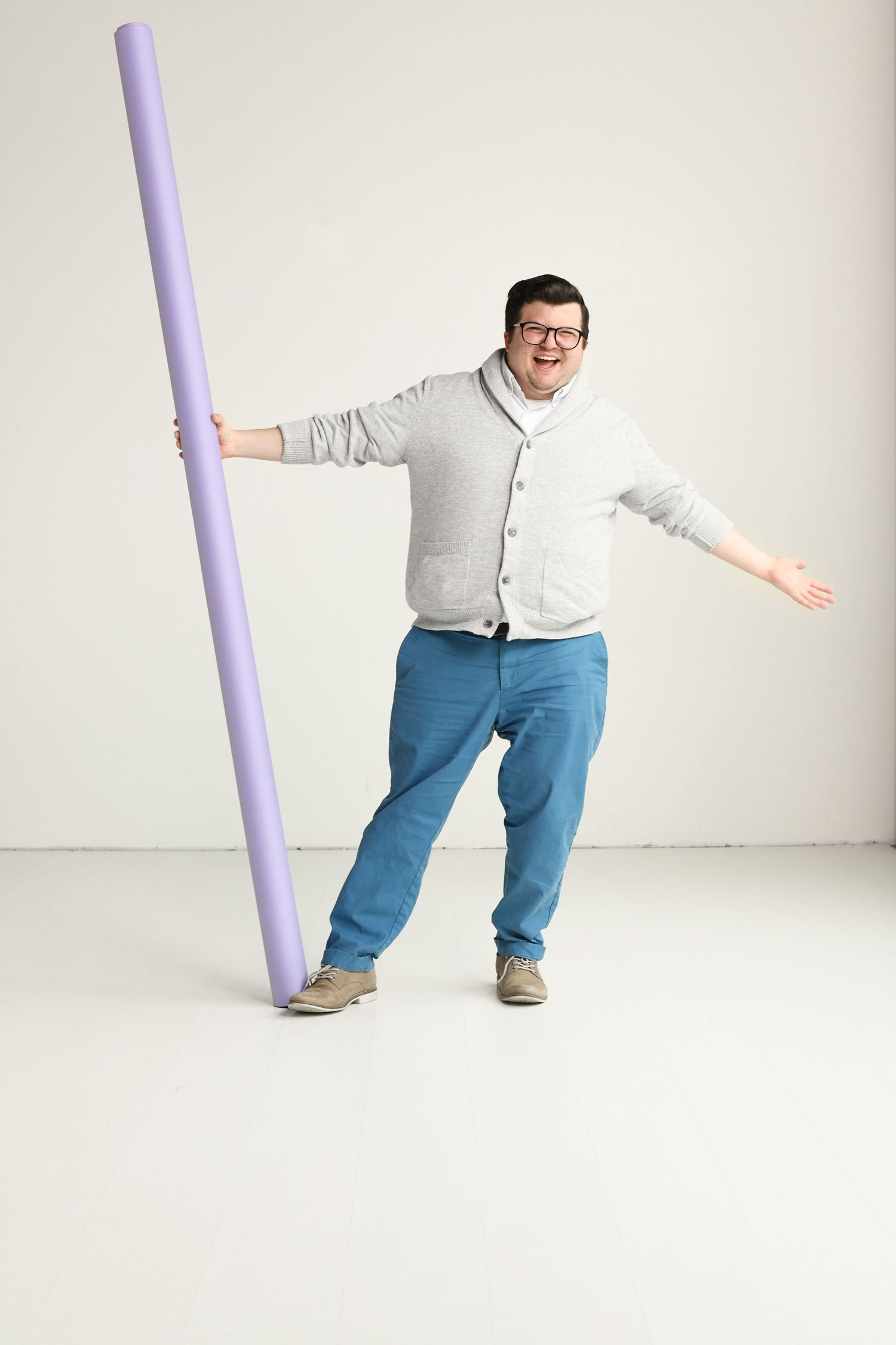 Playful sequence of someone moving and balancing with a purple pole against white background.