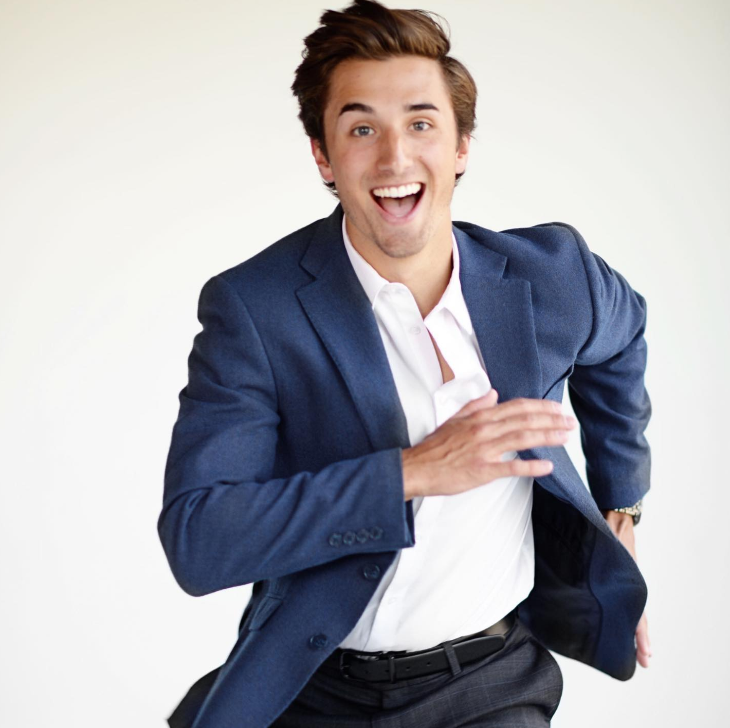 Series of dynamic poses in a navy blue suit against a white background showing playful business expressions.